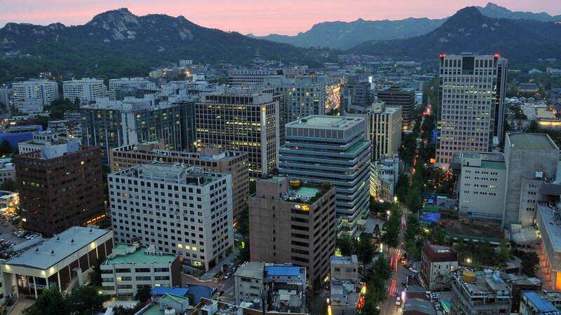 cityscape at dusk with mountains