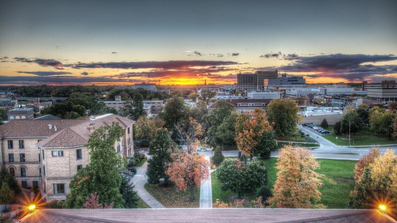 Cityscape at Sunset — Orange, Dramatic, Photograph, Buildings, Trees, Road