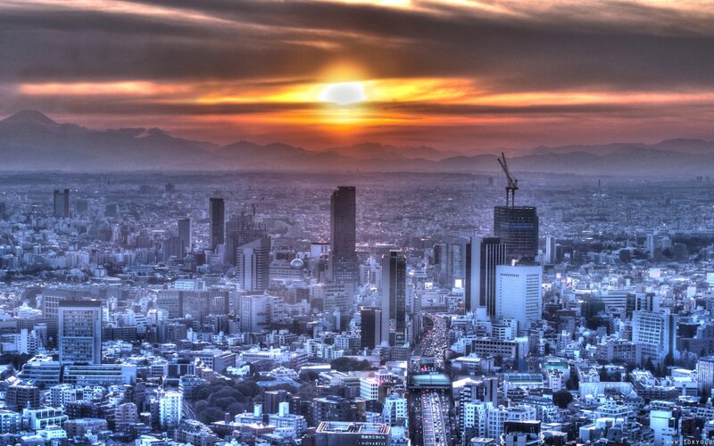 Cityscape at Sunset — Orange, Dramatic, Photograph, Mountains, Skyscrapers
