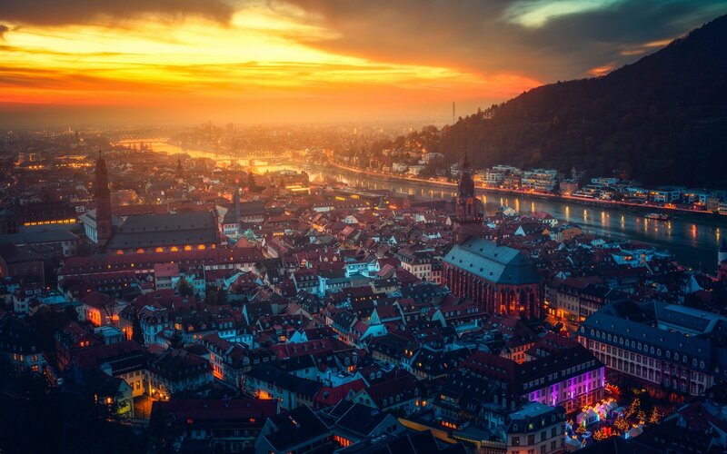 Cityscape at Sunset — Orange, Dramatic, Photograph, River, Buildings, Hills
