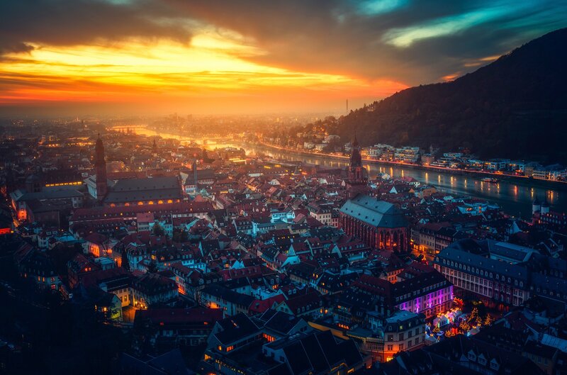 Cityscape at Sunset — Orange, Dramatic, Photograph, River, Buildings, Mountain