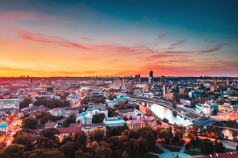Cityscape at Sunset — Orange, Dramatic, Photograph, River, Buildings, Trees