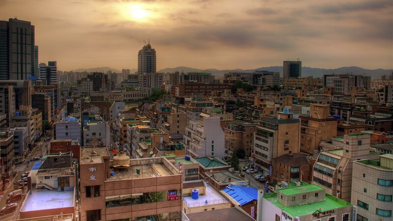 Cityscape at sunset with mountains