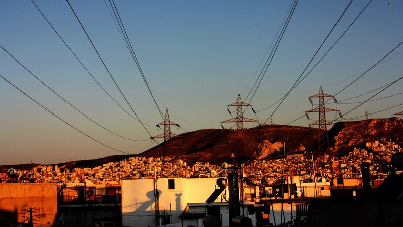 Cityscape at sunset with power lines