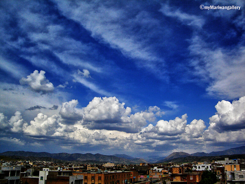 Cityscape under Cloudy Sky — Blue, Dramatic