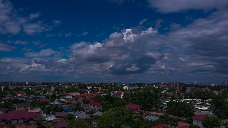 Cityscape under Storm Clouds — Blue
