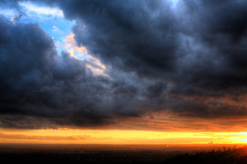 Cityscape under Storm Clouds — Orange