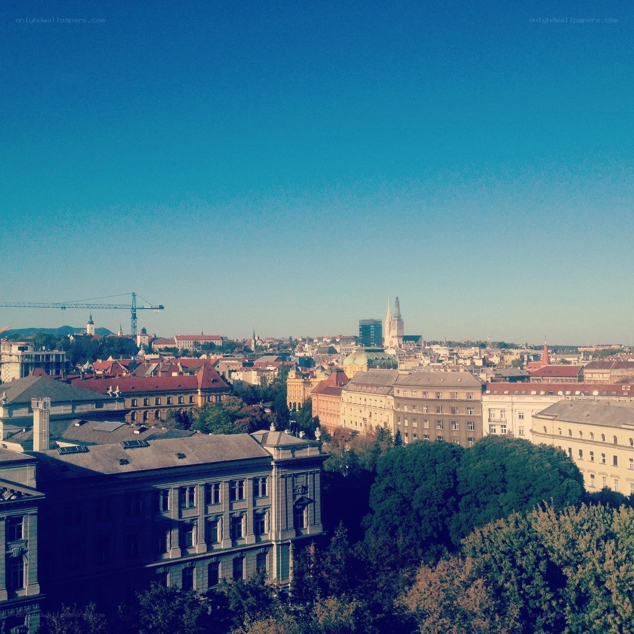cityscape with crane and cathedral