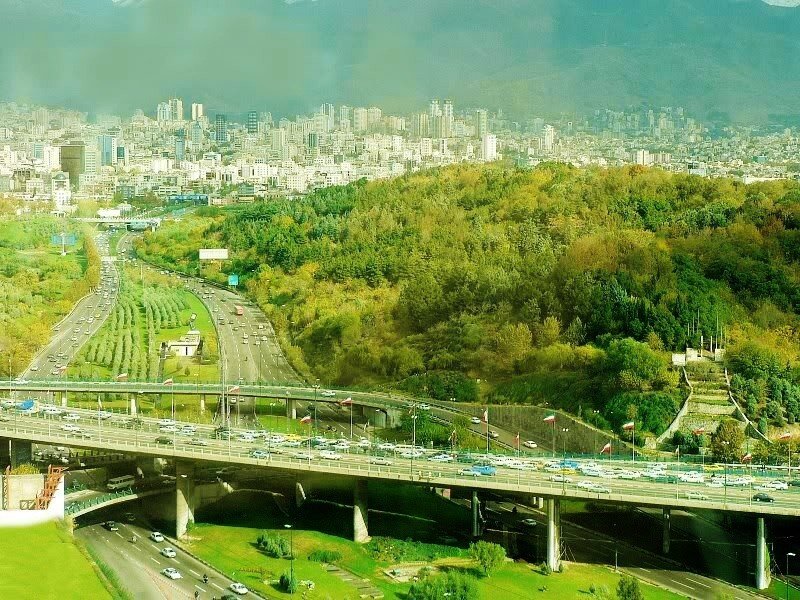 Cityscape with highway and green hills