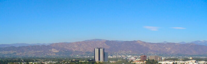 Cityscape with Mountains — Blue, Serene, Afternoon, Photograph, Buildings