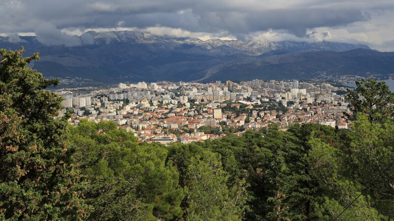 Cityscape with Mountains — Green, Dramatic, Afternoon