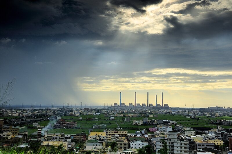Cityscape with power plant under stormy sky