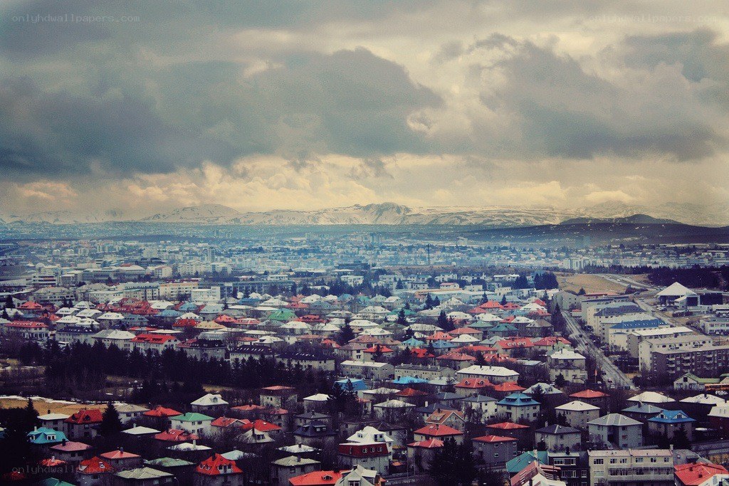 cityscape with snow-capped mountains