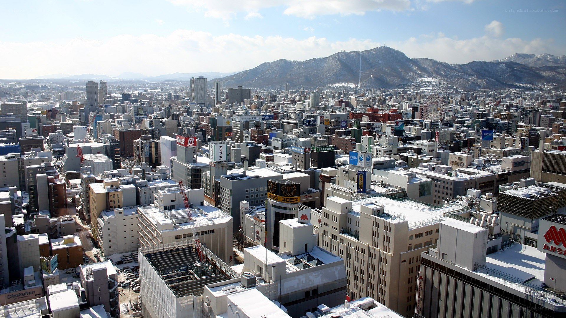 Cityscape with snow-covered mountains