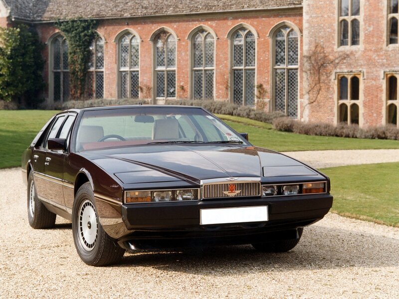 Classic Aston Martin in front of a manor