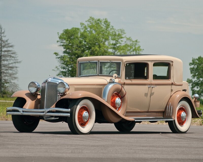 Classic beige car on asphalt
