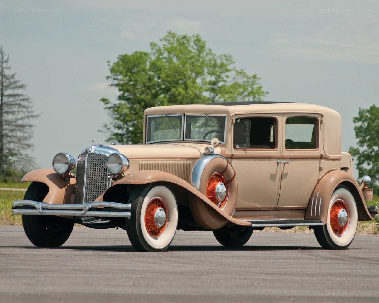 Classic beige car on asphalt