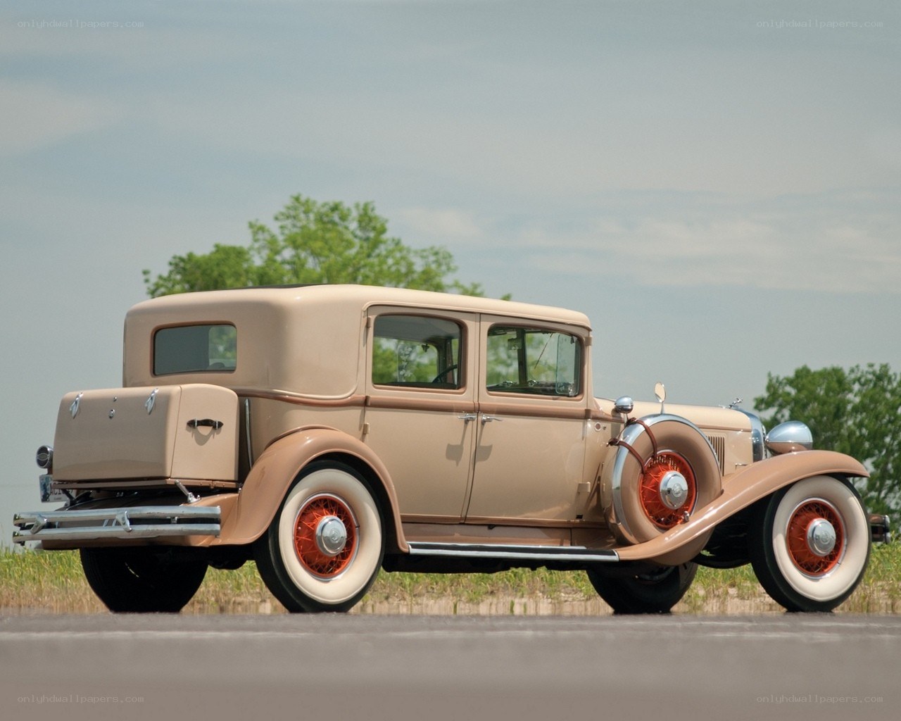 Classic beige car on road