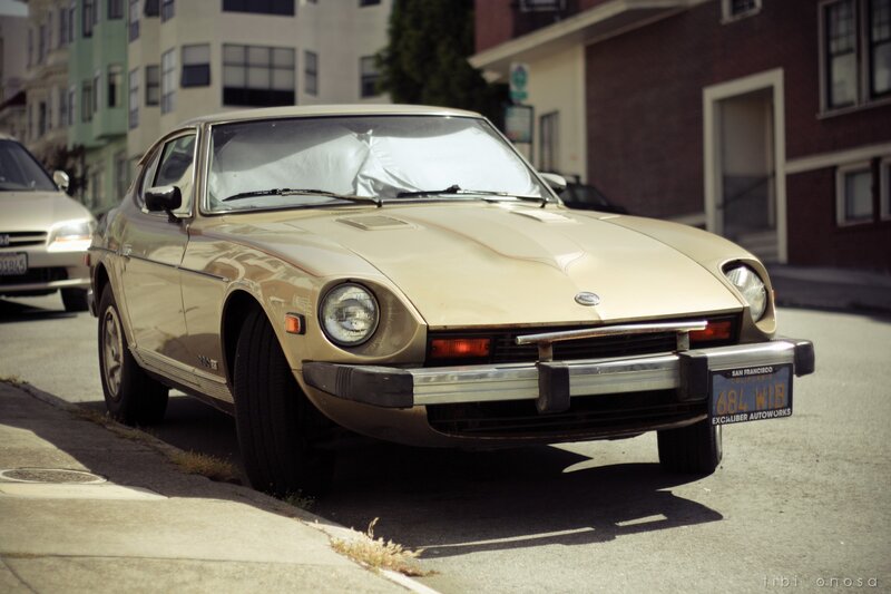 Classic beige Datsun parked on street
