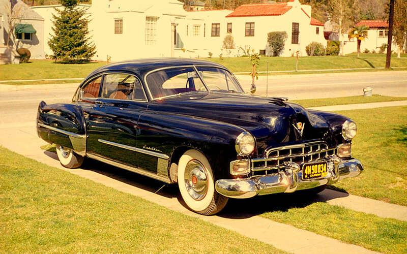 Classic black Cadillac parked on grass