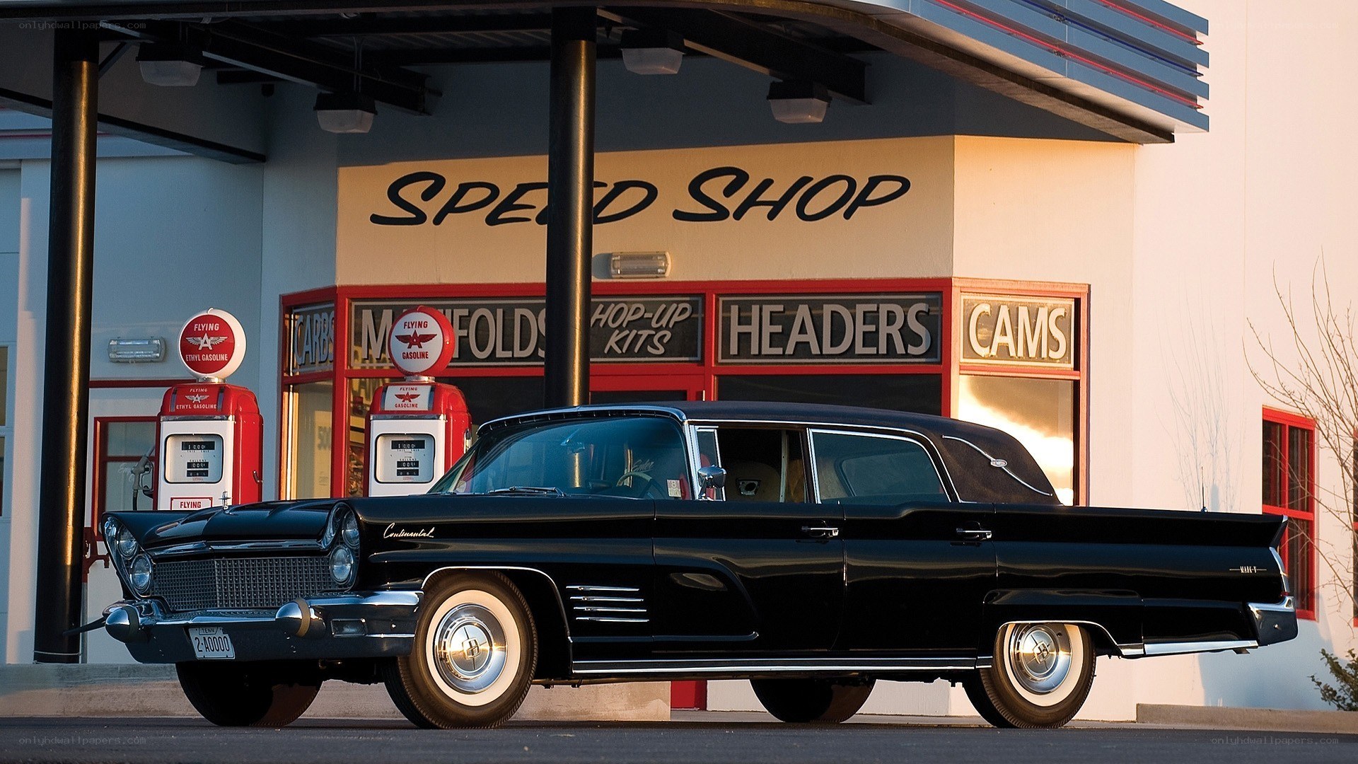 Classic black car at gas station