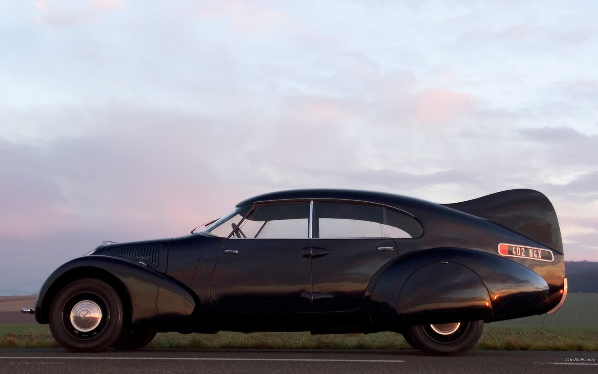 Classic black car at sunset
