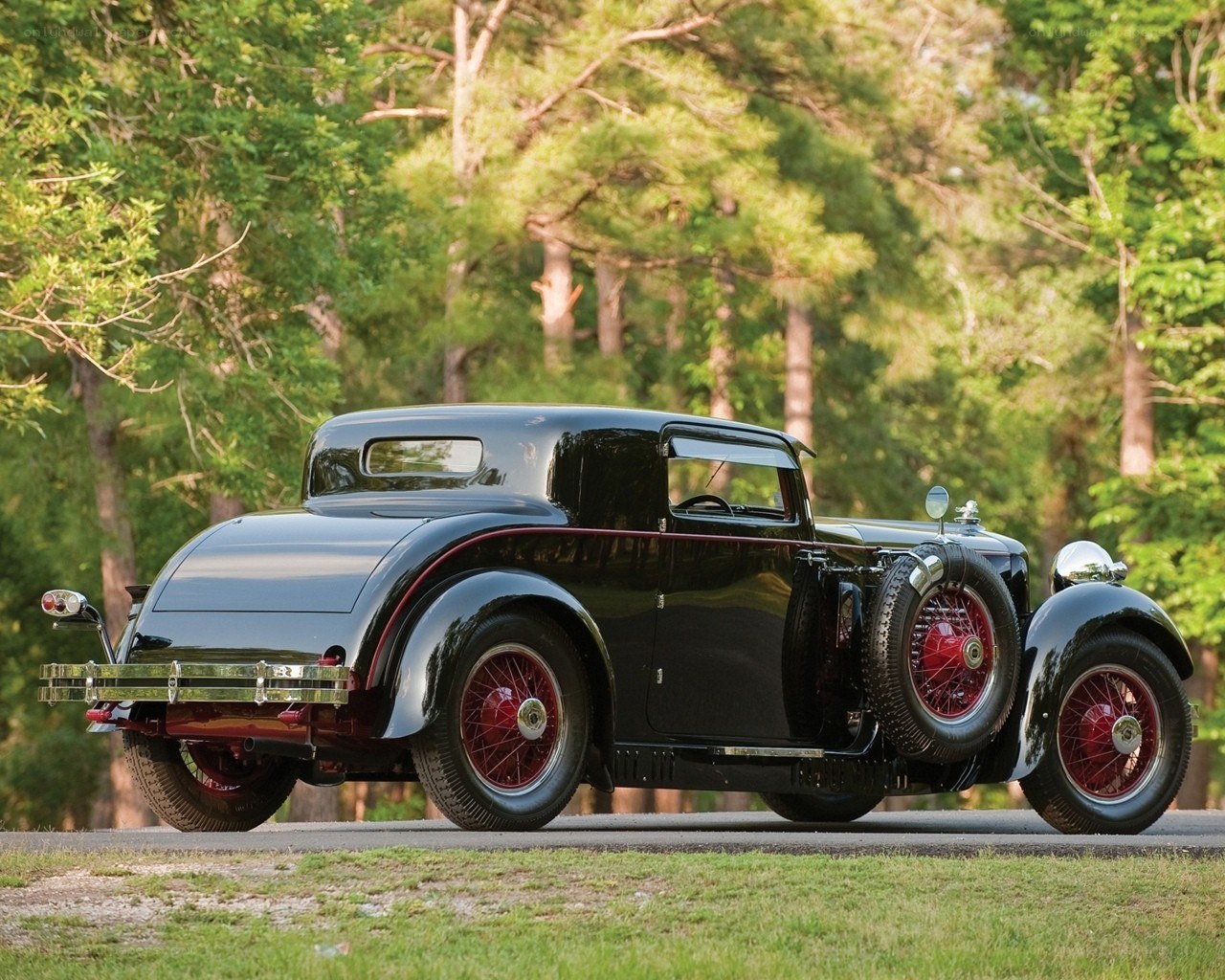 Classic black car in forest