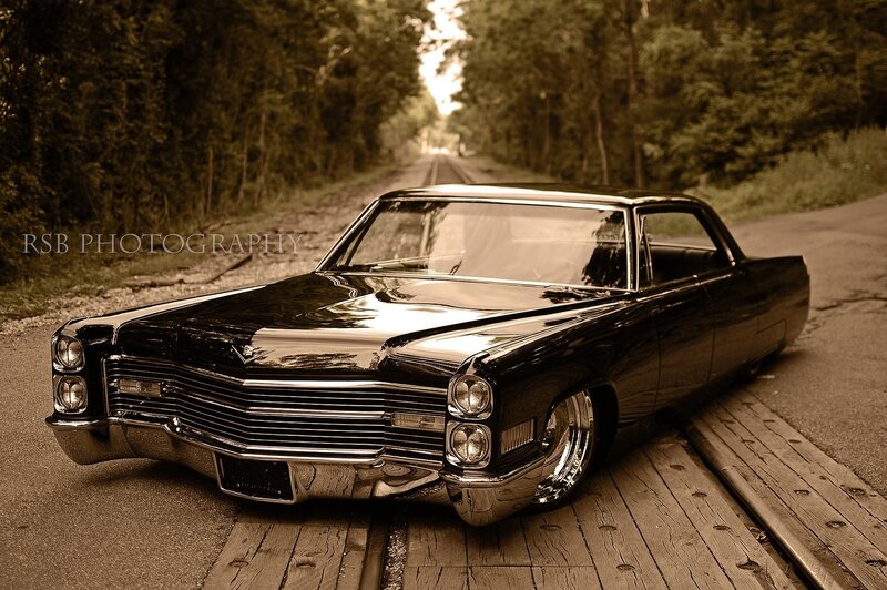Classic black car on a forest road