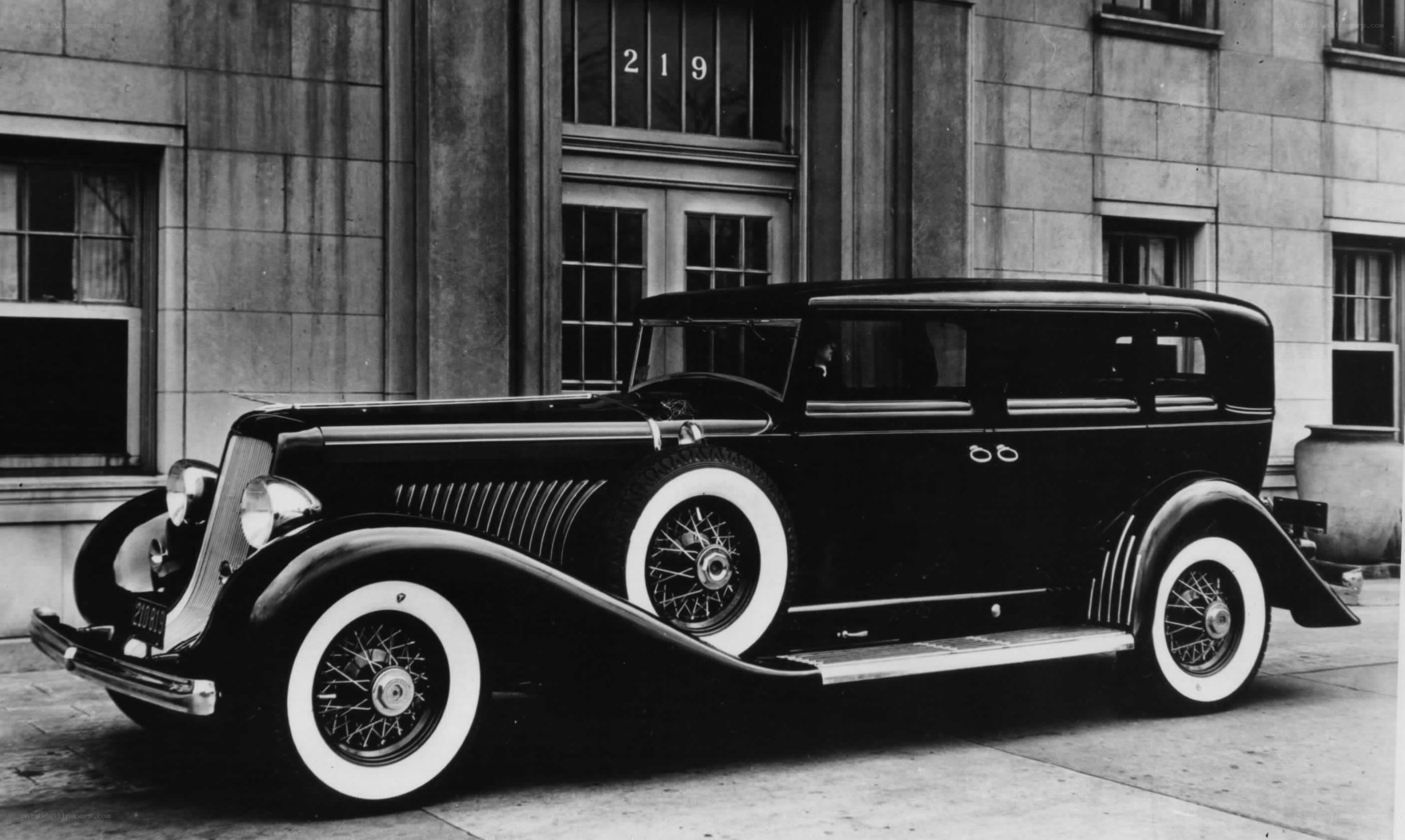 Classic black car parked outside building