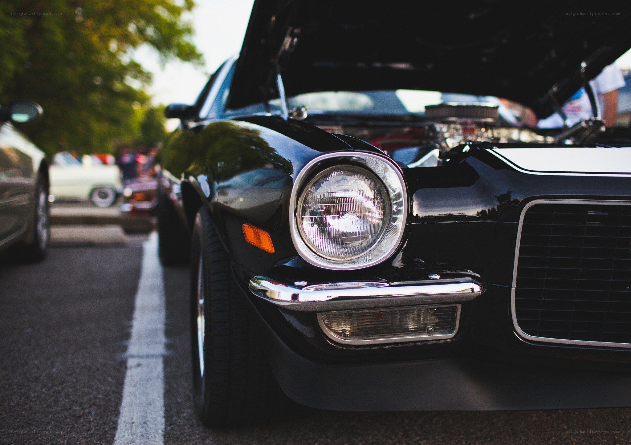 Classic black car with open hood