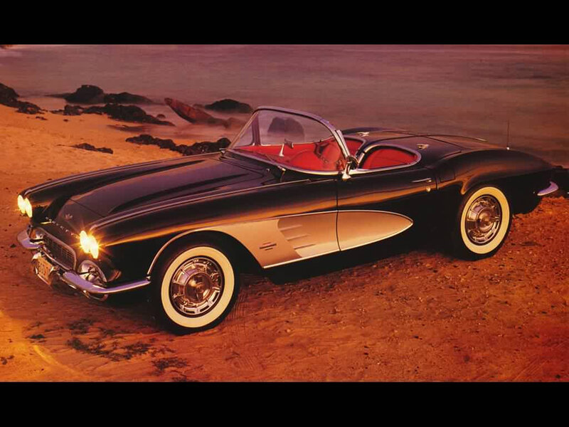 Classic black Corvette on beach