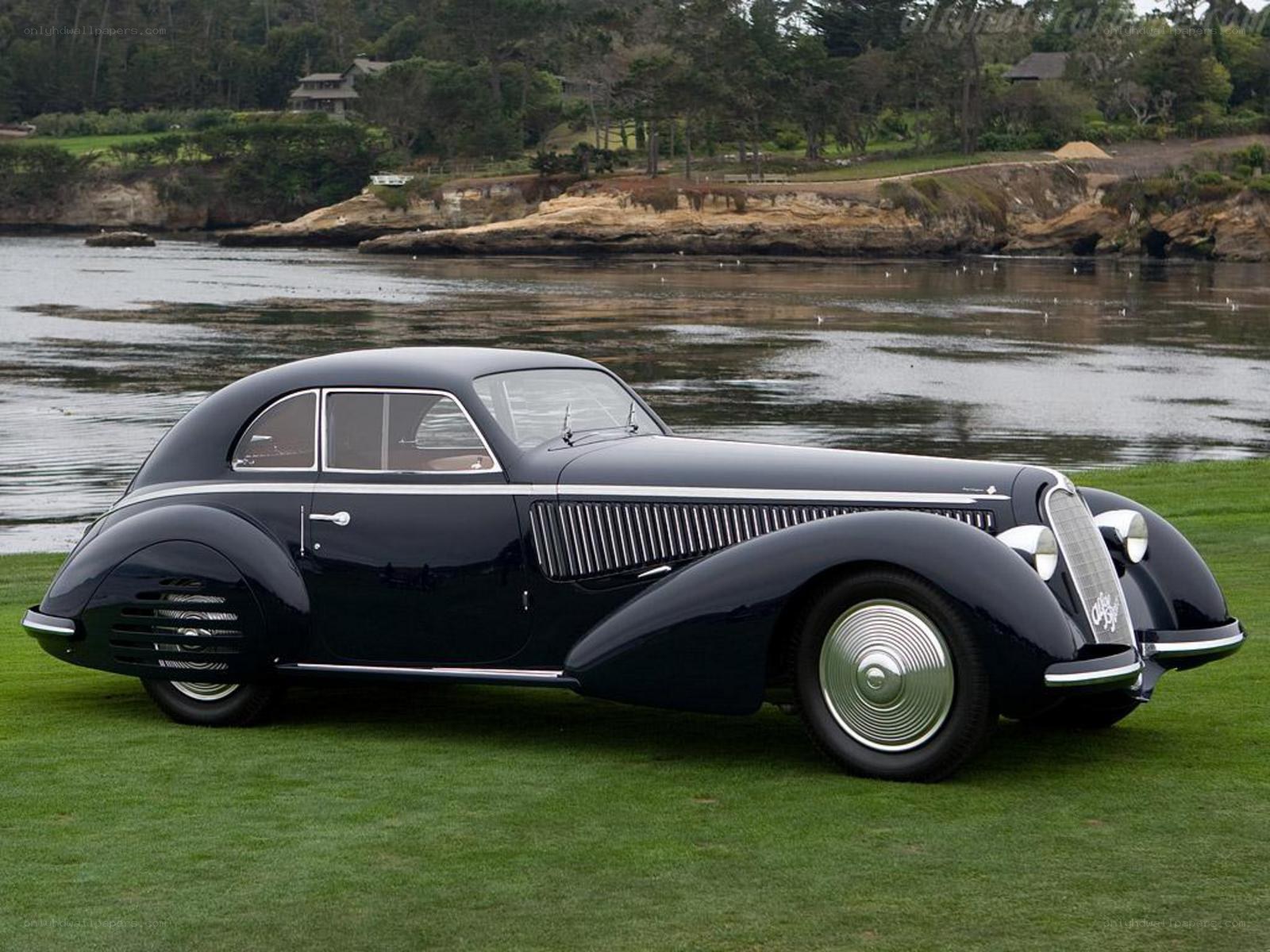 Classic black coupe by water