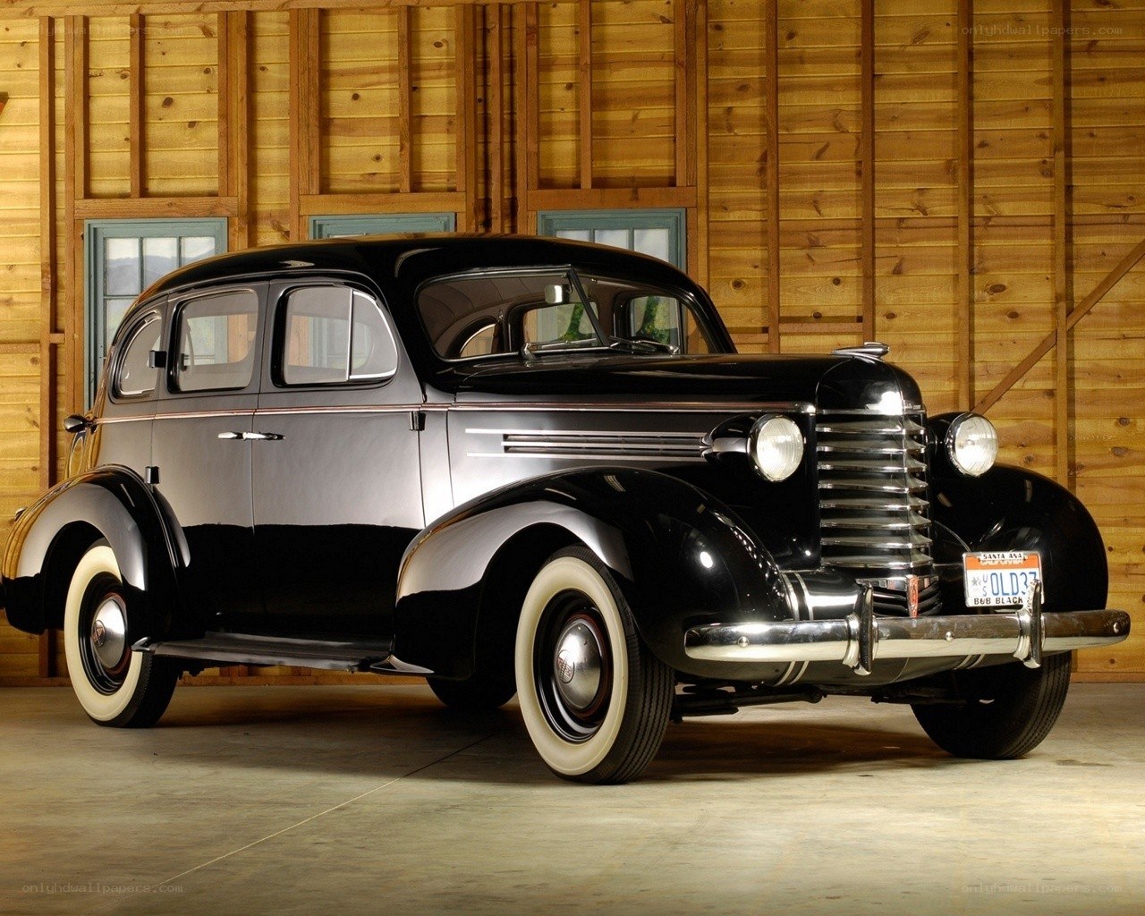 Classic black sedan in barn