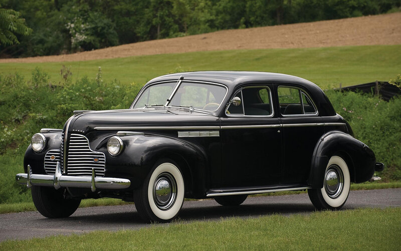 Classic black sedan on a country road