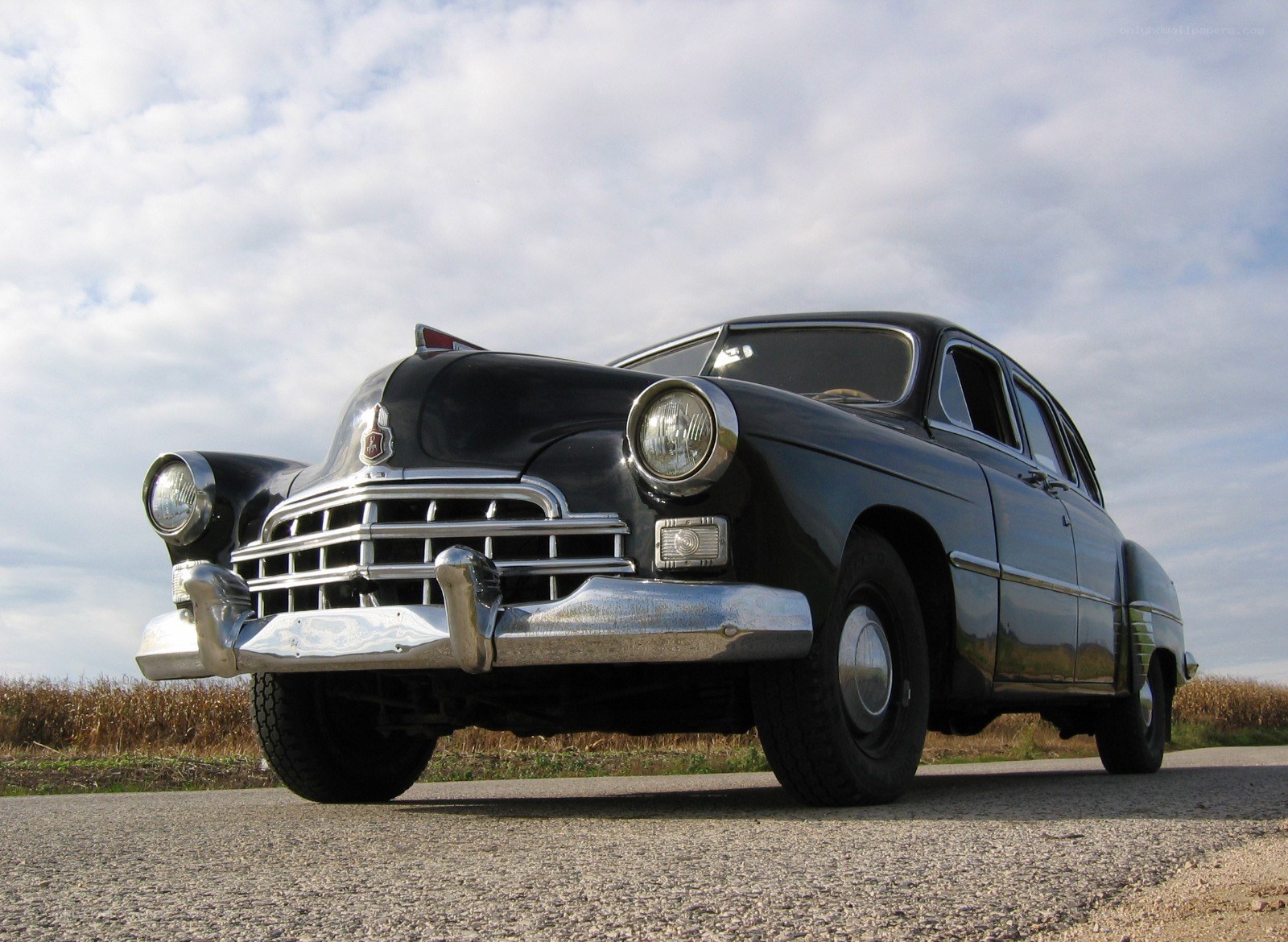 Classic black sedan on road