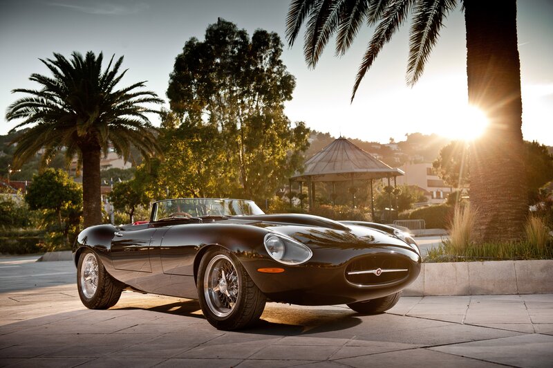 Classic black sports car at sunset