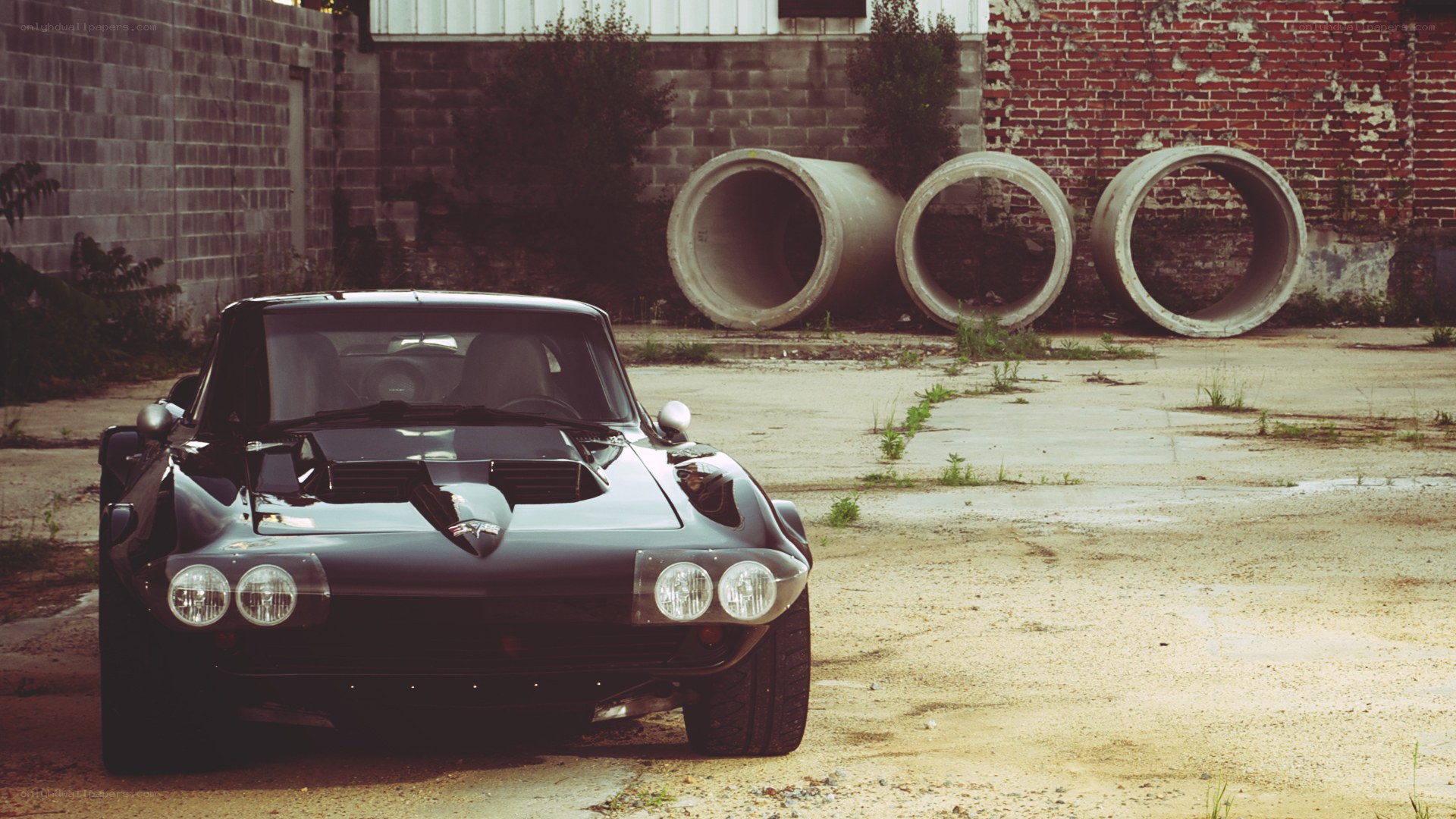 Classic black sports car in industrial lot