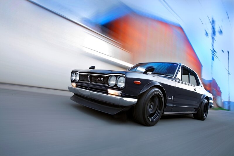 classic black sports car in motion