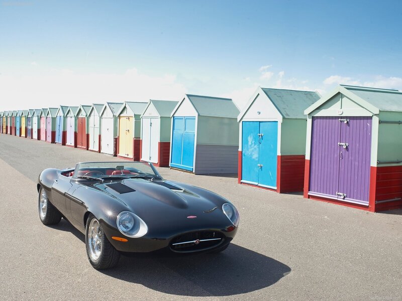Classic black sports car on beach