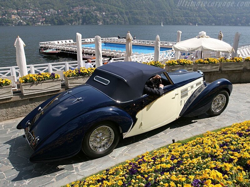 Classic blue and cream car by lake