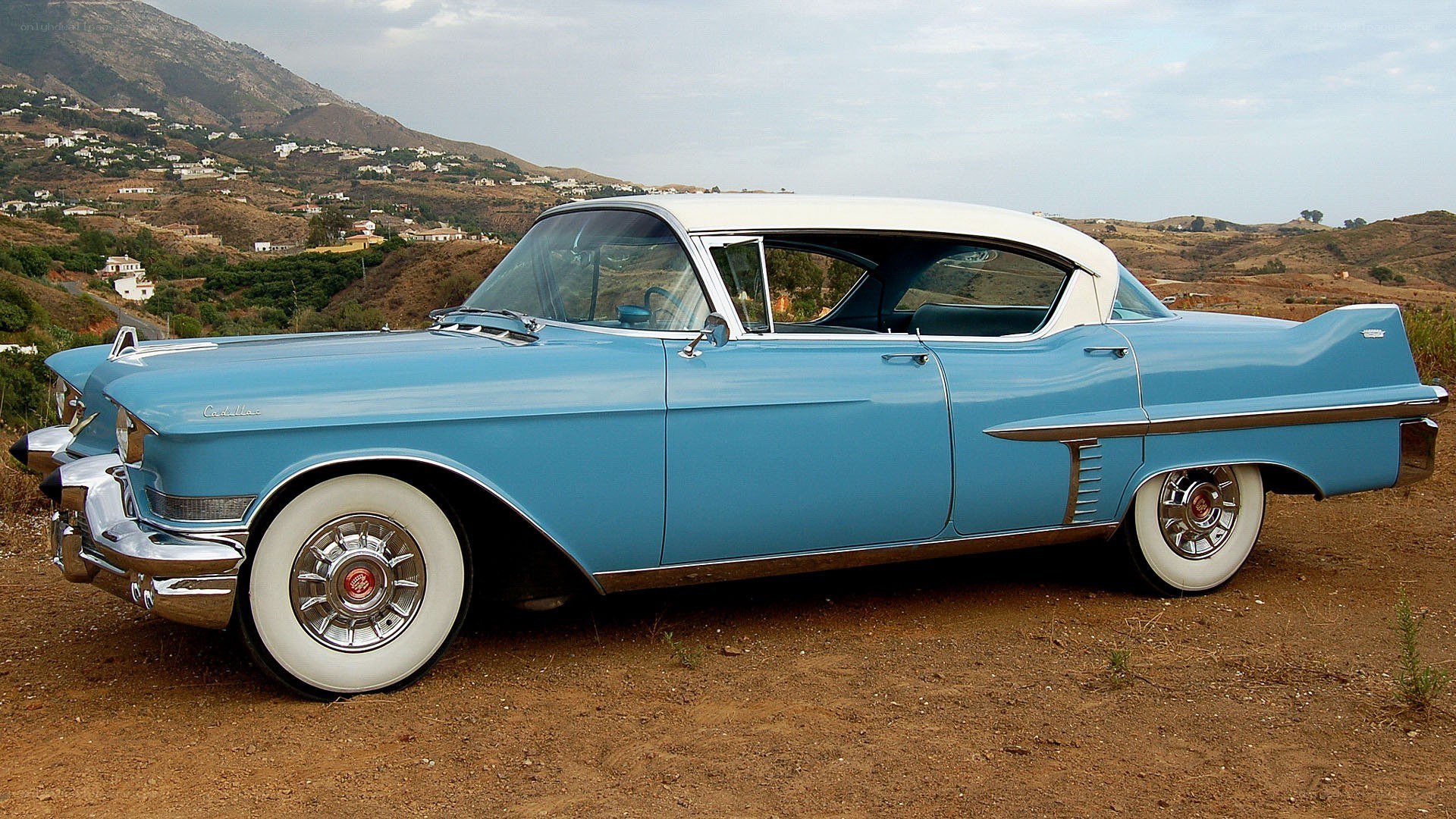Classic blue Cadillac on a hillside