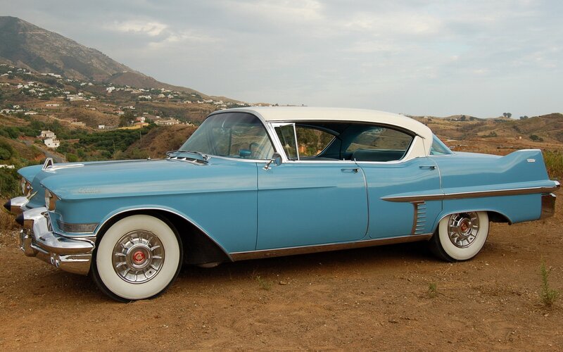 Classic blue Cadillac parked on a hill