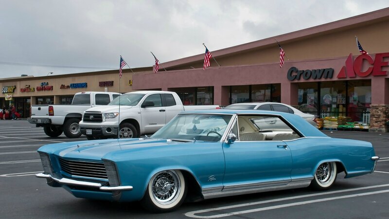Classic blue car in parking lot