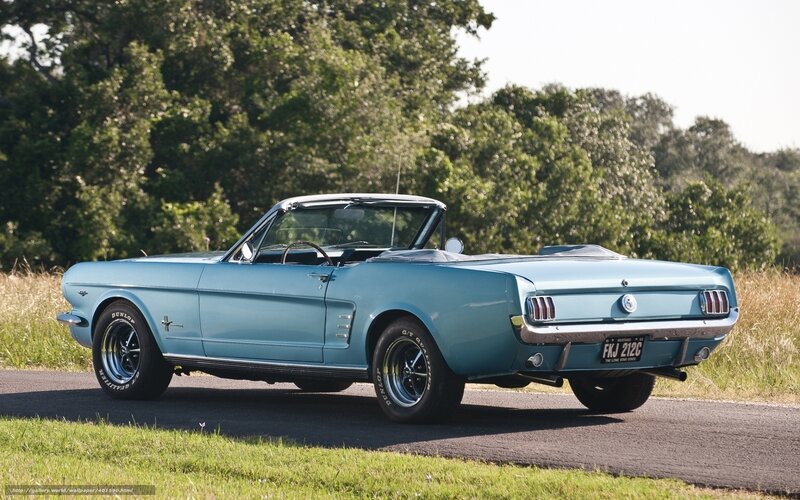 Classic blue convertible on a country road