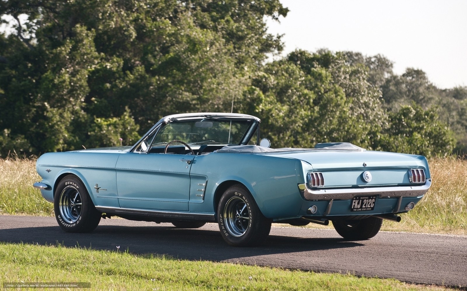 Classic blue convertible on a country road