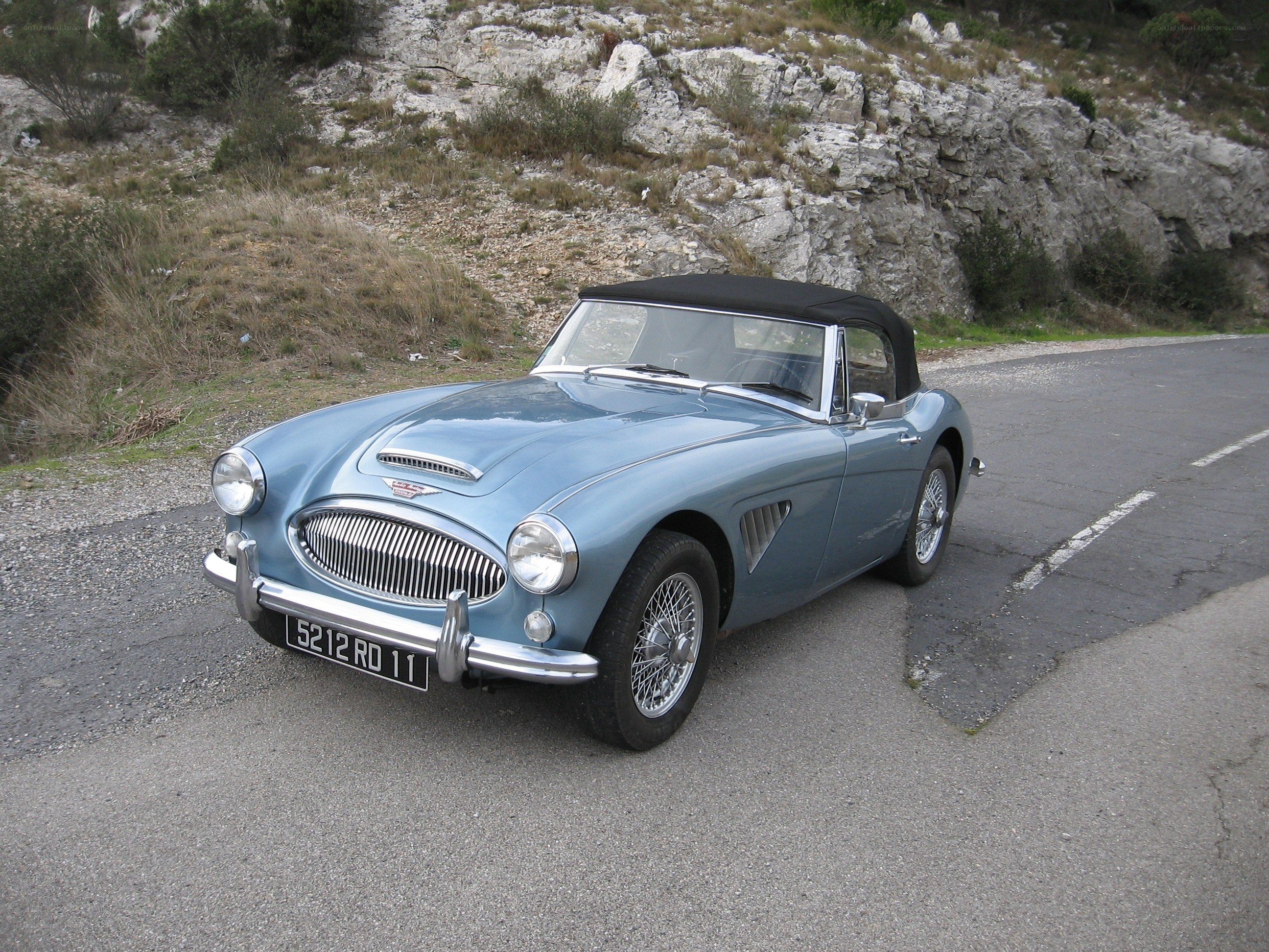 Classic blue convertible on a road