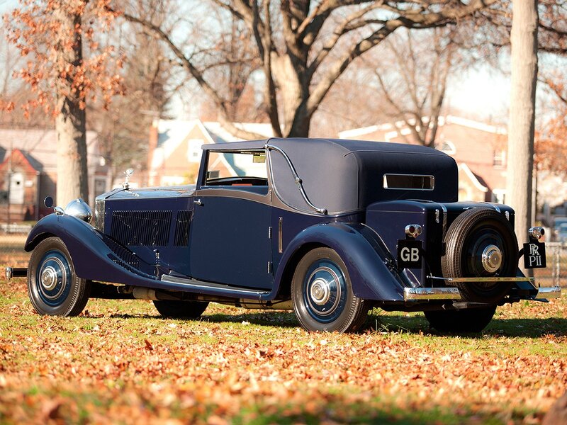 Classic blue Rolls-Royce on autumn lawn