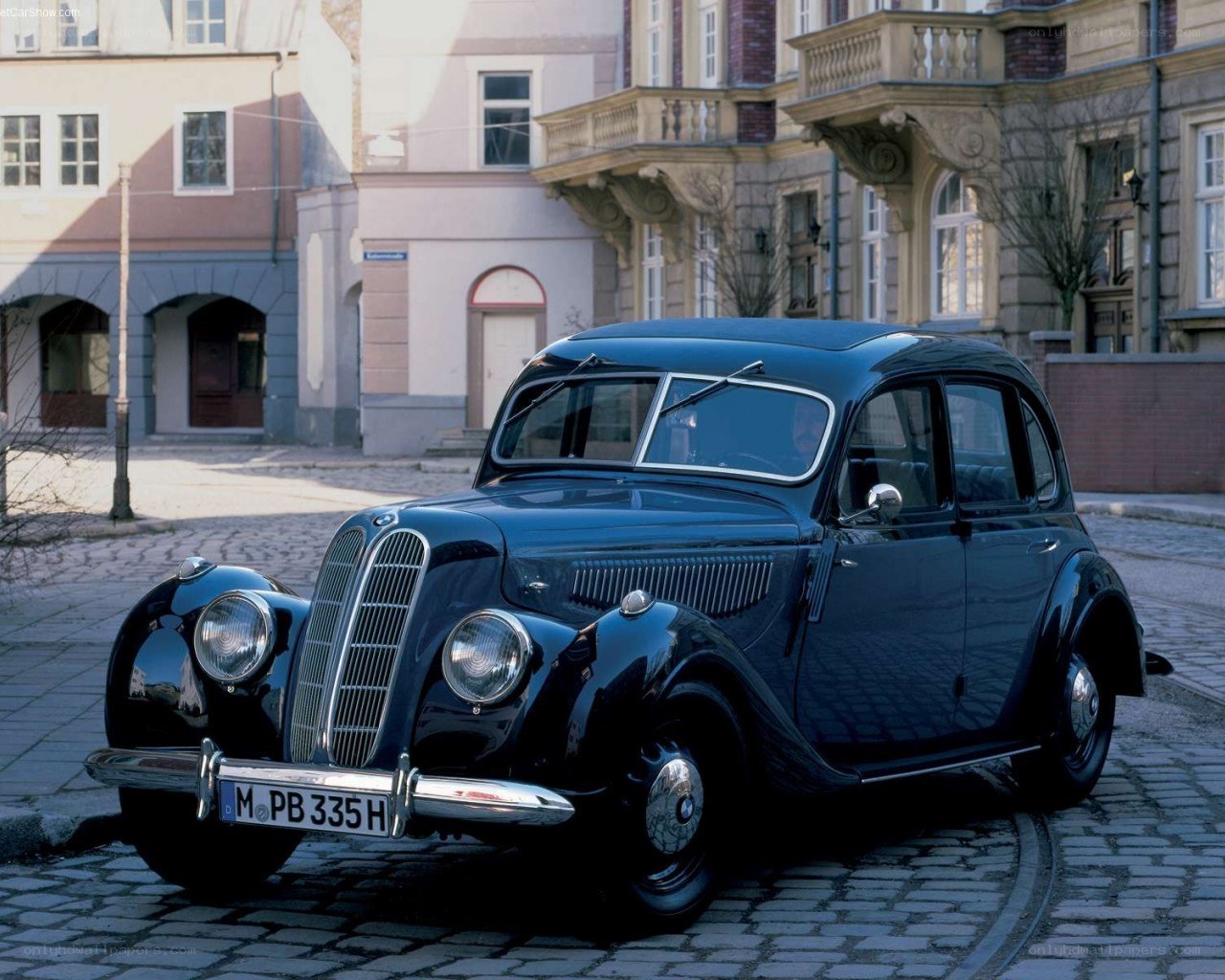 Classic BMW sedan on cobblestones