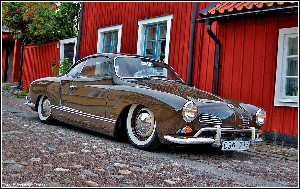 Classic brown car on cobblestone street