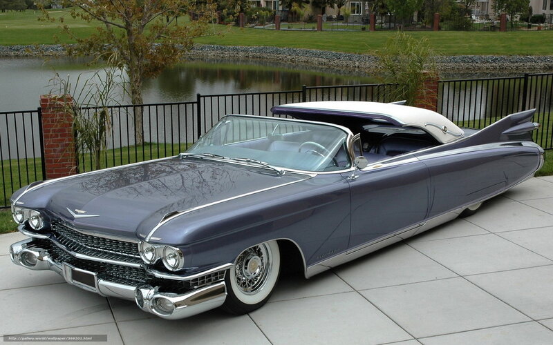 Classic Cadillac convertible by a pond